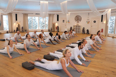Tantra Student's perform bhujangasana in guided tantra yoga class